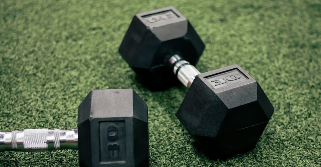 Two 30 lb hex dumbbells resting on vibrant green turf, fitness and exercise concept.